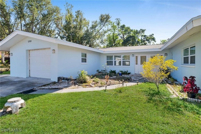 view of front of home with a garage and a front lawn