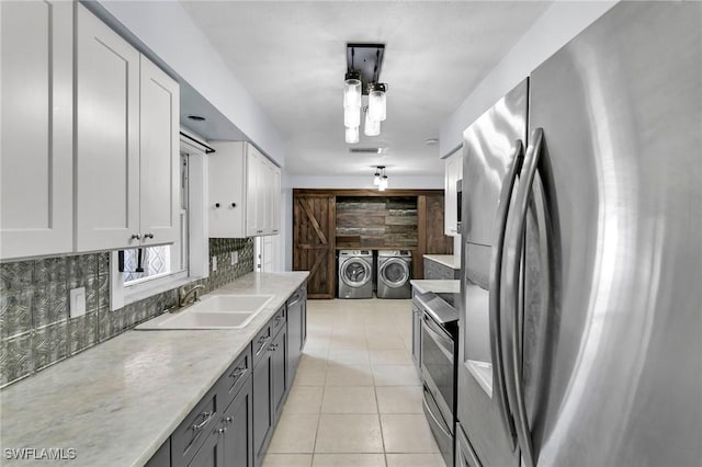 kitchen with stainless steel refrigerator with ice dispenser, backsplash, sink, washer and dryer, and white cabinets