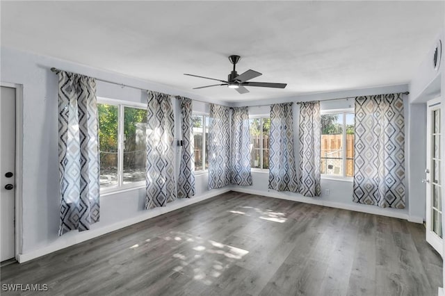 spare room with ceiling fan and dark wood-type flooring