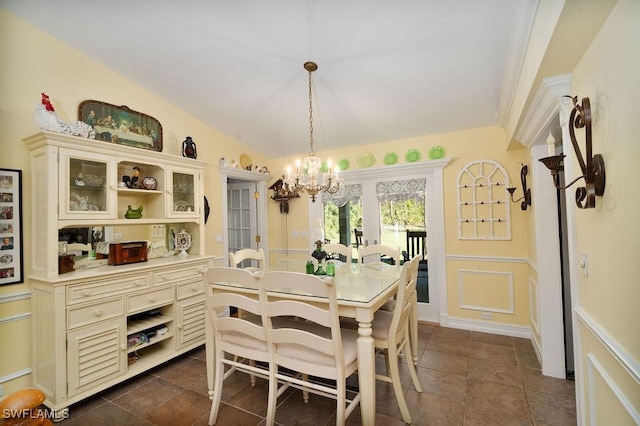 tiled dining space with a chandelier and vaulted ceiling