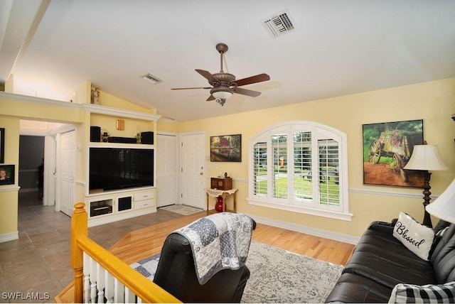 living room with hardwood / wood-style flooring, ceiling fan, and lofted ceiling