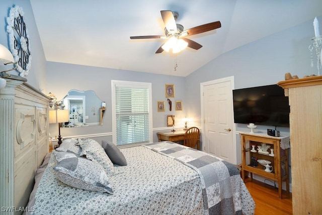 bedroom featuring hardwood / wood-style flooring, ceiling fan, and vaulted ceiling