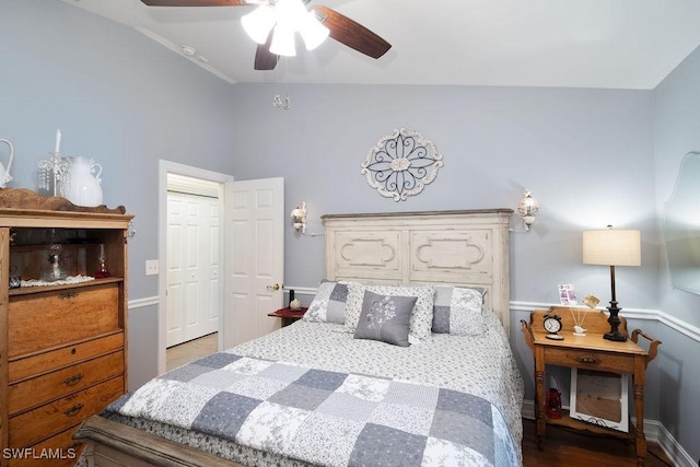 bedroom featuring wood-type flooring, ceiling fan, and a closet