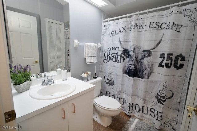 bathroom with vanity, tile patterned floors, toilet, and walk in shower