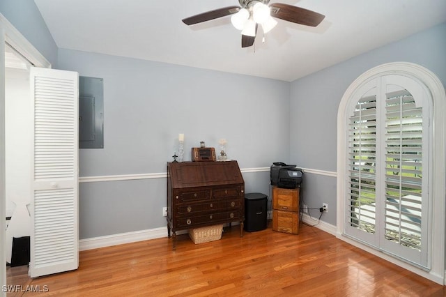 interior space featuring ceiling fan, electric panel, and light hardwood / wood-style flooring