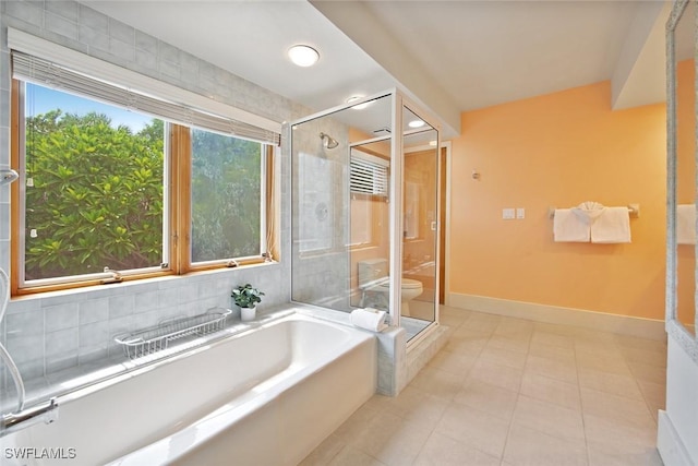 bathroom with shower with separate bathtub, tile patterned floors, and a wealth of natural light