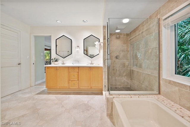 bathroom with vanity and separate shower and tub