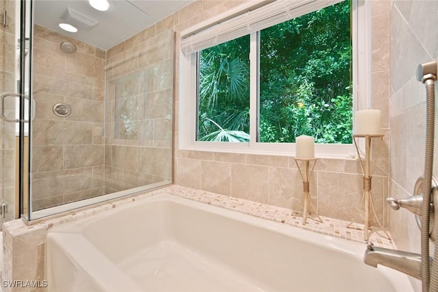 bathroom with separate shower and tub