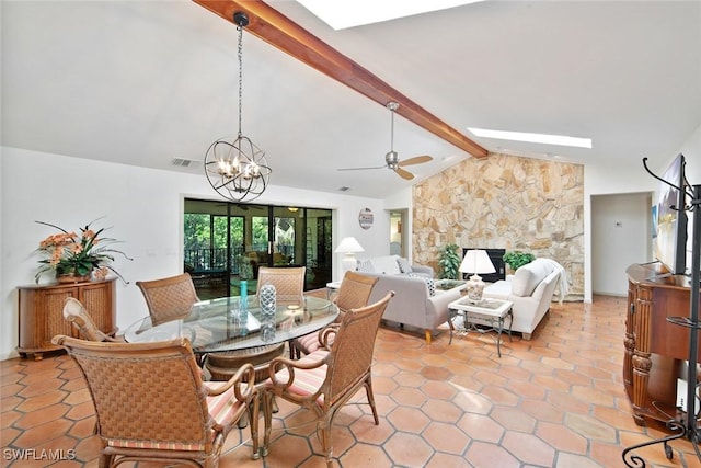 tiled dining area featuring vaulted ceiling with beams, a fireplace, and ceiling fan with notable chandelier