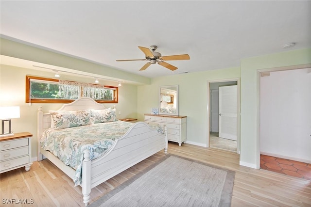 bedroom with light hardwood / wood-style floors and ceiling fan