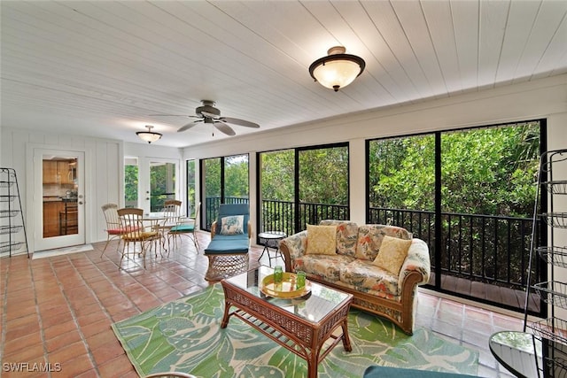 sunroom with ceiling fan, french doors, and wooden ceiling