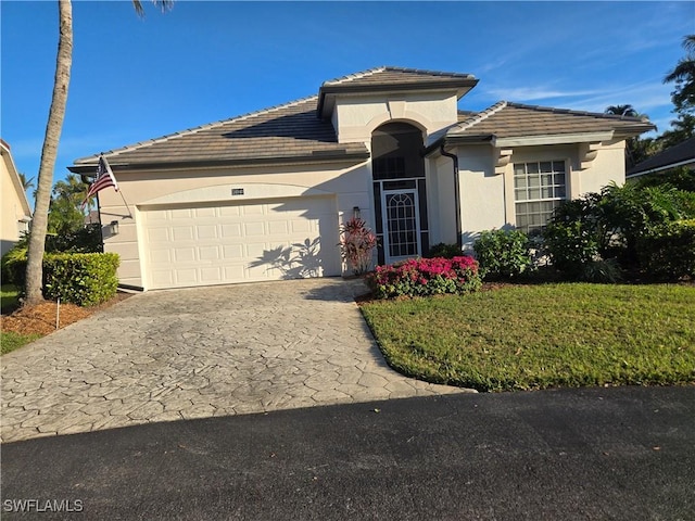 view of front of house with a garage and a front lawn