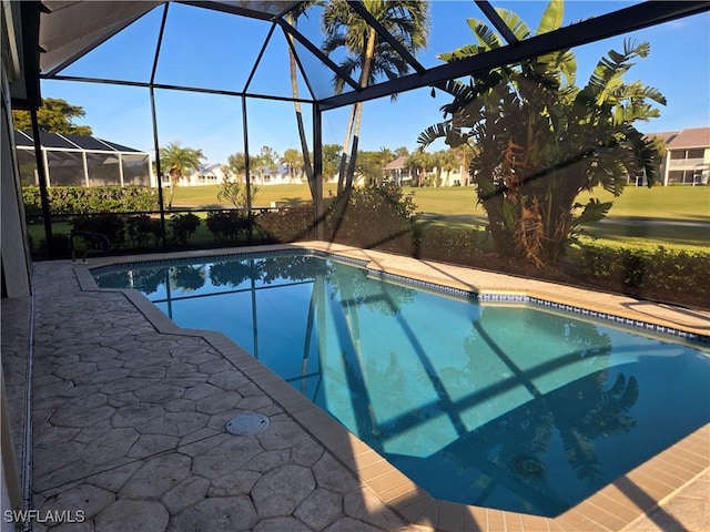 view of pool featuring glass enclosure