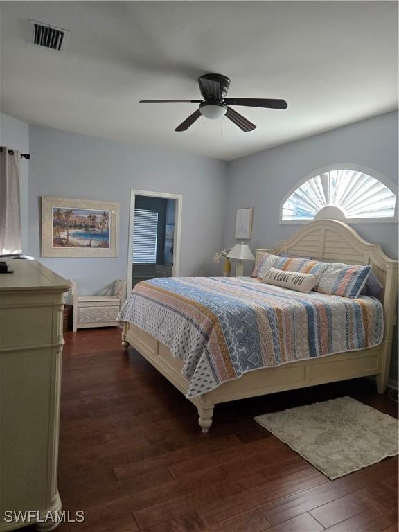 bedroom featuring ceiling fan and dark hardwood / wood-style flooring