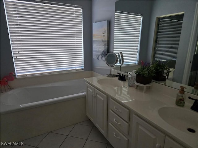 bathroom with tile patterned flooring, vanity, and a washtub