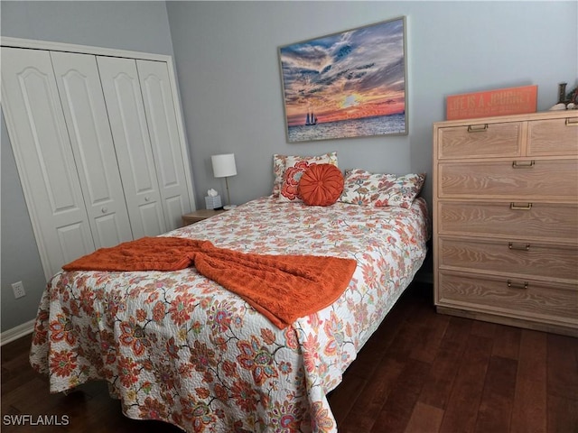 bedroom featuring dark hardwood / wood-style flooring and a closet