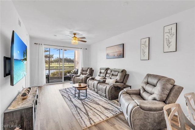 living room with ceiling fan and light hardwood / wood-style flooring