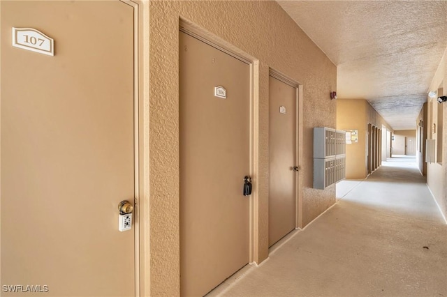 hall with a textured ceiling