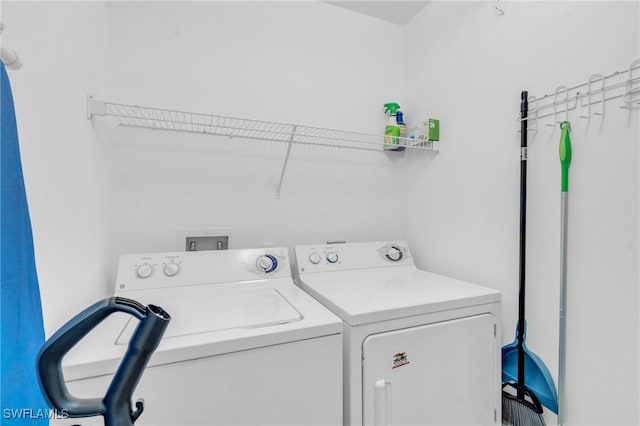 washroom featuring washer and clothes dryer