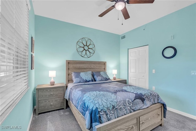 carpeted bedroom featuring ceiling fan and a closet