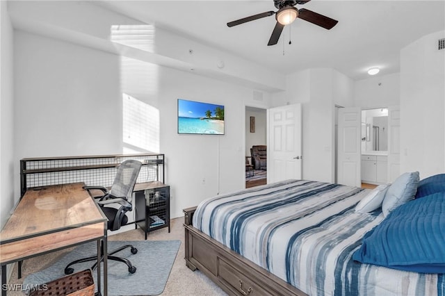 carpeted bedroom featuring ceiling fan and ensuite bath