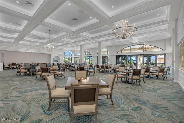 dining area featuring plenty of natural light, carpet floors, and a notable chandelier