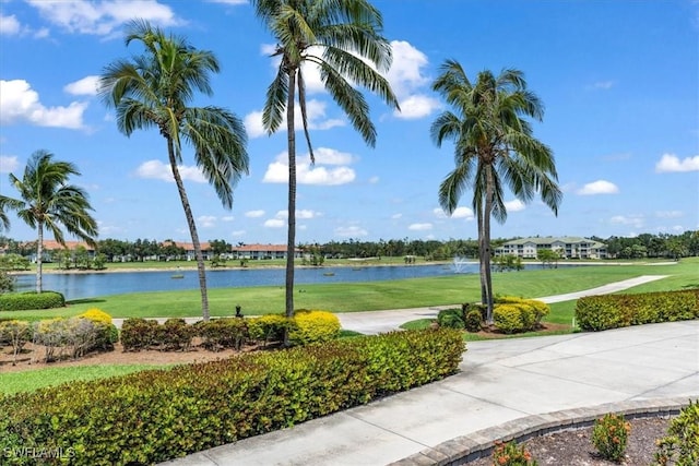 view of home's community featuring a water view and a yard