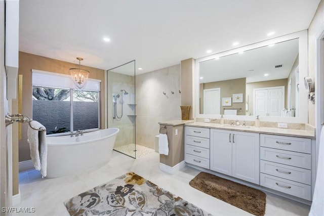 bathroom with vanity, separate shower and tub, and an inviting chandelier