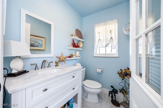 bathroom with tile patterned floors, vanity, and toilet