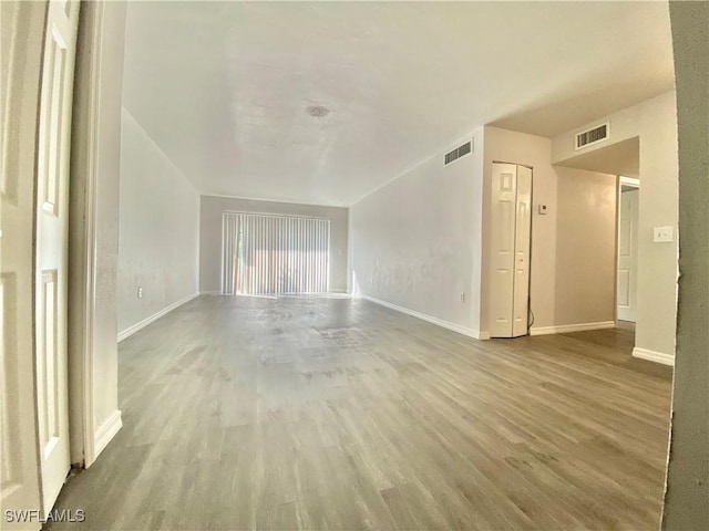 unfurnished living room featuring wood-type flooring