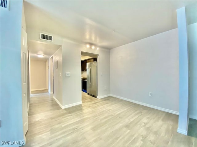 spare room with light hardwood / wood-style floors