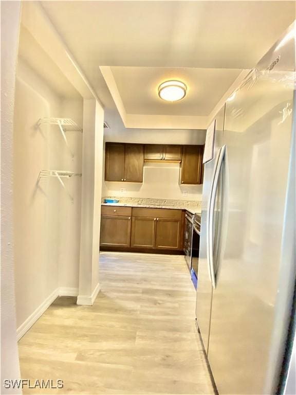 kitchen featuring light hardwood / wood-style floors and stainless steel refrigerator