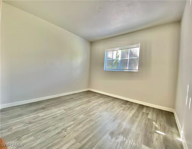 spare room with light hardwood / wood-style flooring