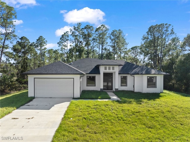 view of front of property featuring a front lawn and a garage