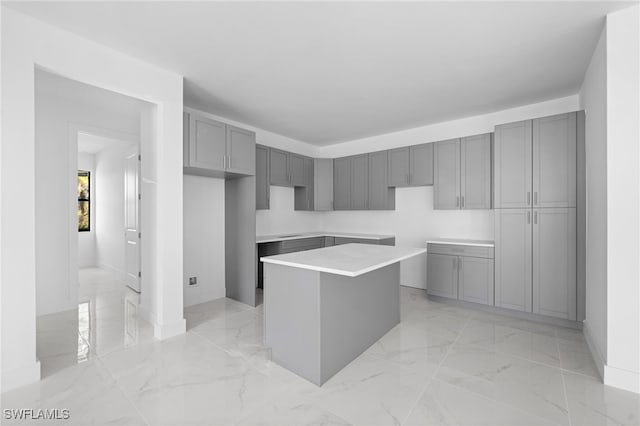 kitchen with a kitchen island and gray cabinetry