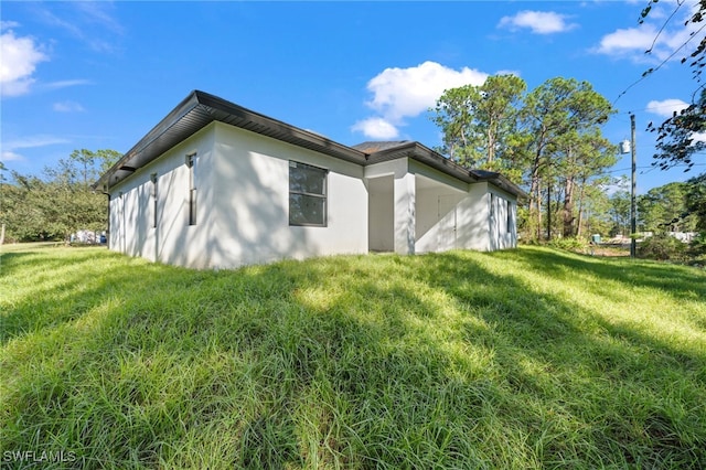 view of property exterior with a yard