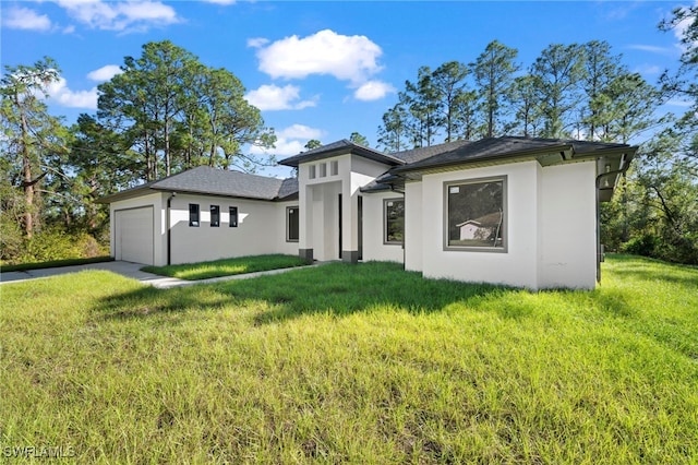 prairie-style home featuring a garage and a front yard