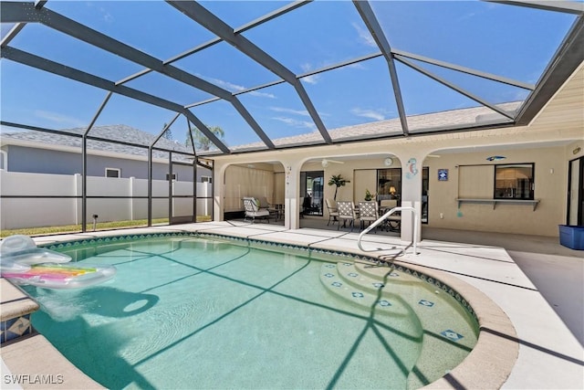 view of pool with ceiling fan, a lanai, and a patio