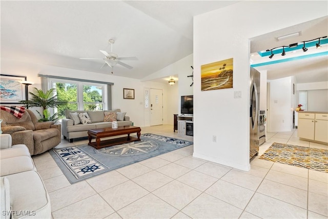 living room featuring ceiling fan, light tile patterned floors, and lofted ceiling