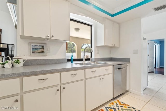 kitchen featuring dishwasher, white cabinets, sink, ornamental molding, and light tile patterned flooring