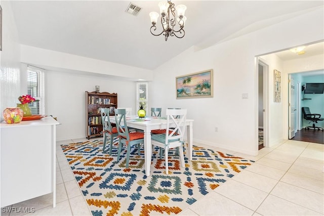 dining area featuring light tile patterned floors, an inviting chandelier, and vaulted ceiling