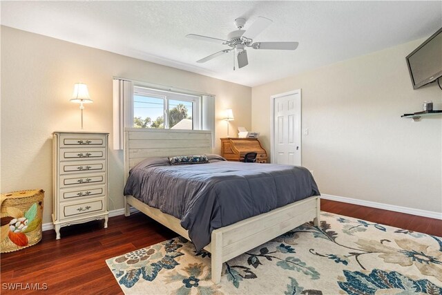 bedroom with ceiling fan and dark hardwood / wood-style floors