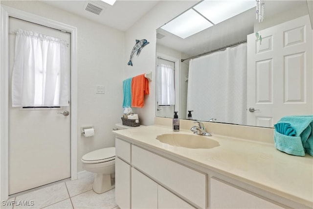 bathroom with tile patterned flooring, vanity, and toilet