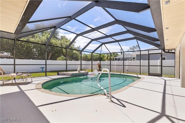 view of pool with a patio area and a lanai