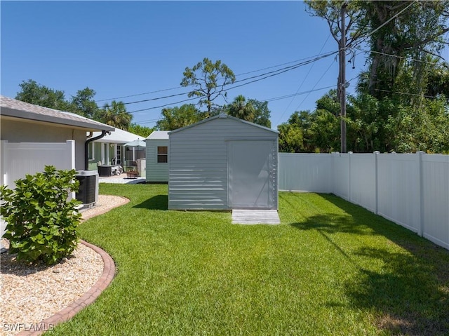 view of yard with cooling unit and a shed