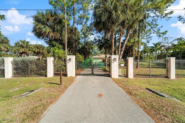 view of gate featuring a yard