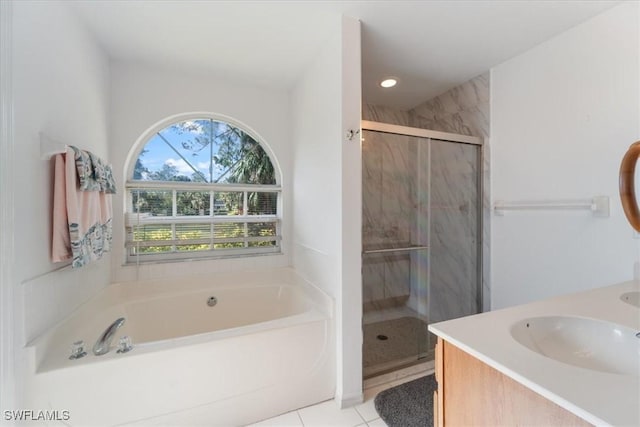 bathroom featuring tile patterned flooring, vanity, and shower with separate bathtub