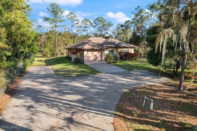 view of front of home featuring a garage and a front yard