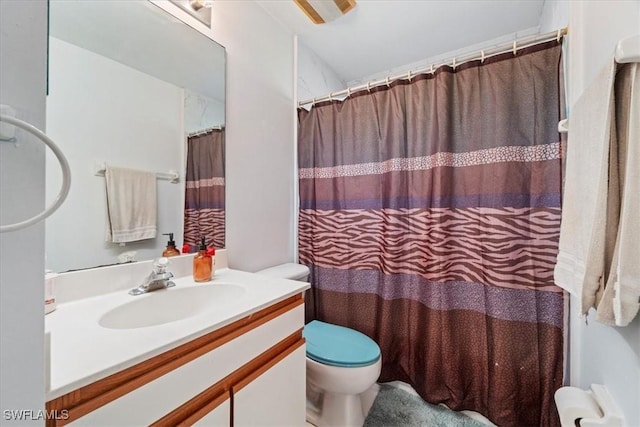 bathroom with vanity, curtained shower, and toilet