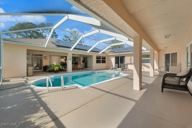 view of pool with a lanai and a patio